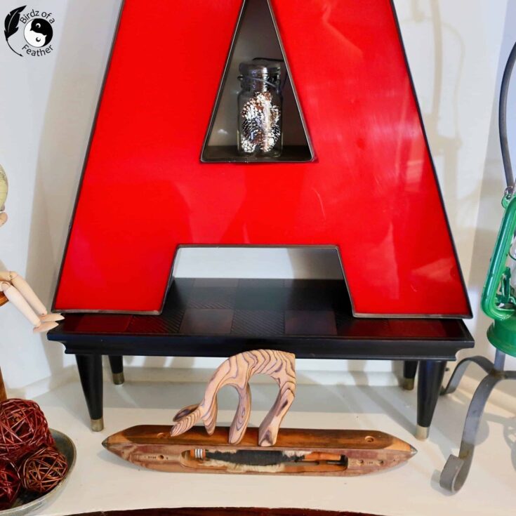 large A sitting on small shelf