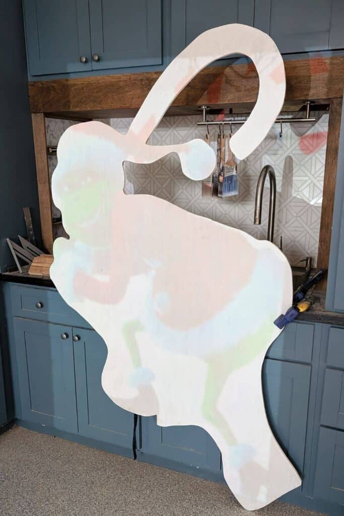 projecting Grinch image on plywood cutout, showing that it's not lining up