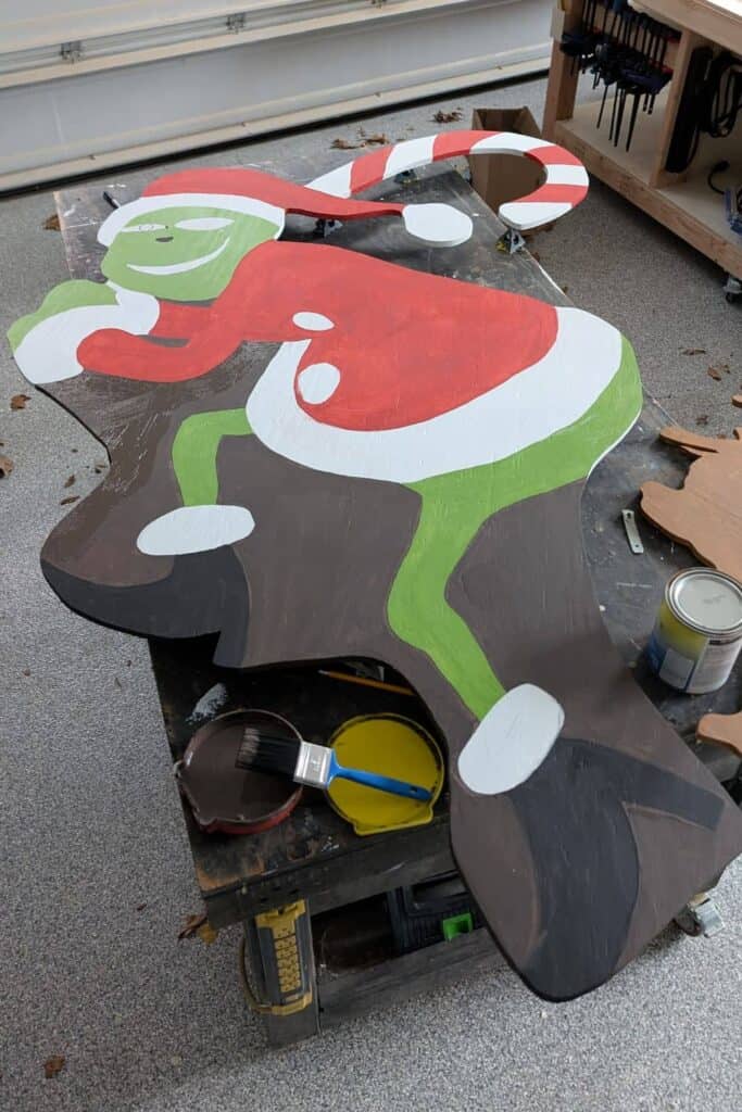 DIY Grinch decoration after painting first coat of paint in every color