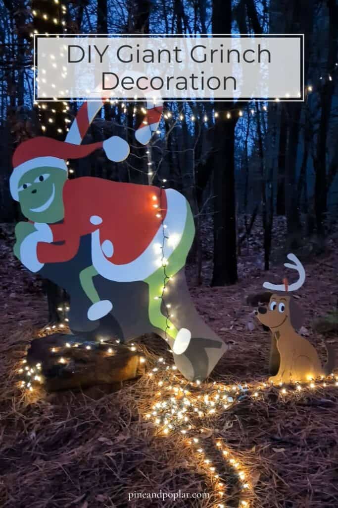 DIY giant Grinch decoration outside in woods stealing Christmas lights