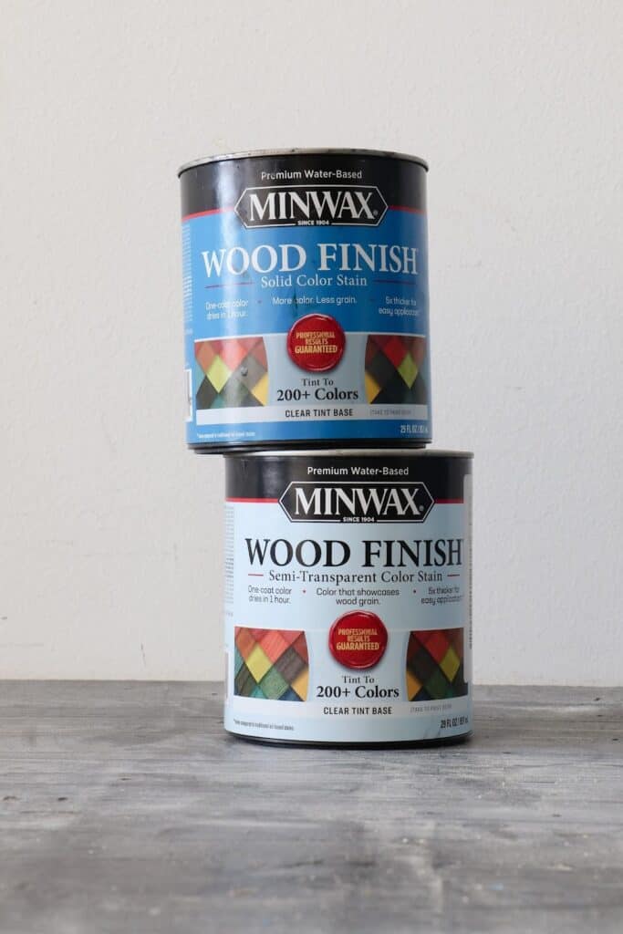Minwax Wood Finish Solid Stain can stacked on top of Minwax Wood Finish Semi-Transparent Color stain can