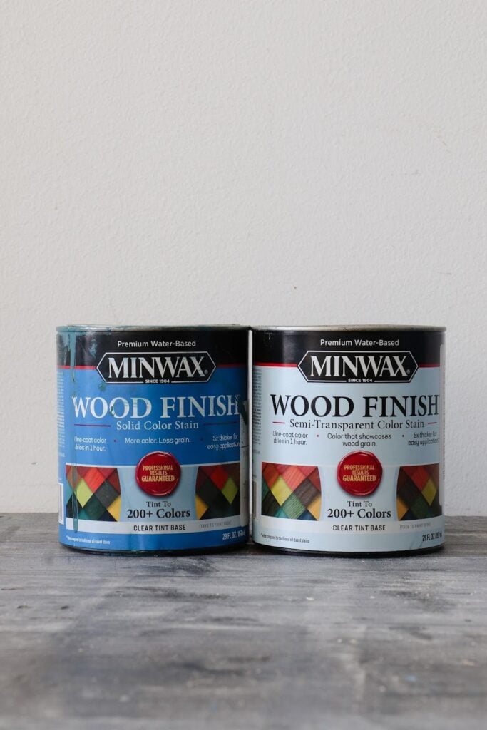 Minwax Wood Finish Solid Color Stain can next to Minwax Wood Finish Semi-transparent color stain can