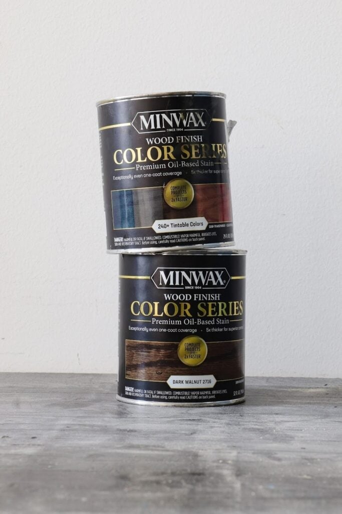 Minwax Wood Finish Color Series stain can in 240+ tintable colors stacked on can tinted to Dark Walnut 