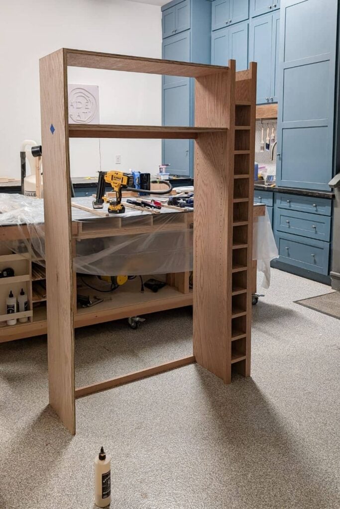 DIY hutch with wine rack attached after being assembled in the garage