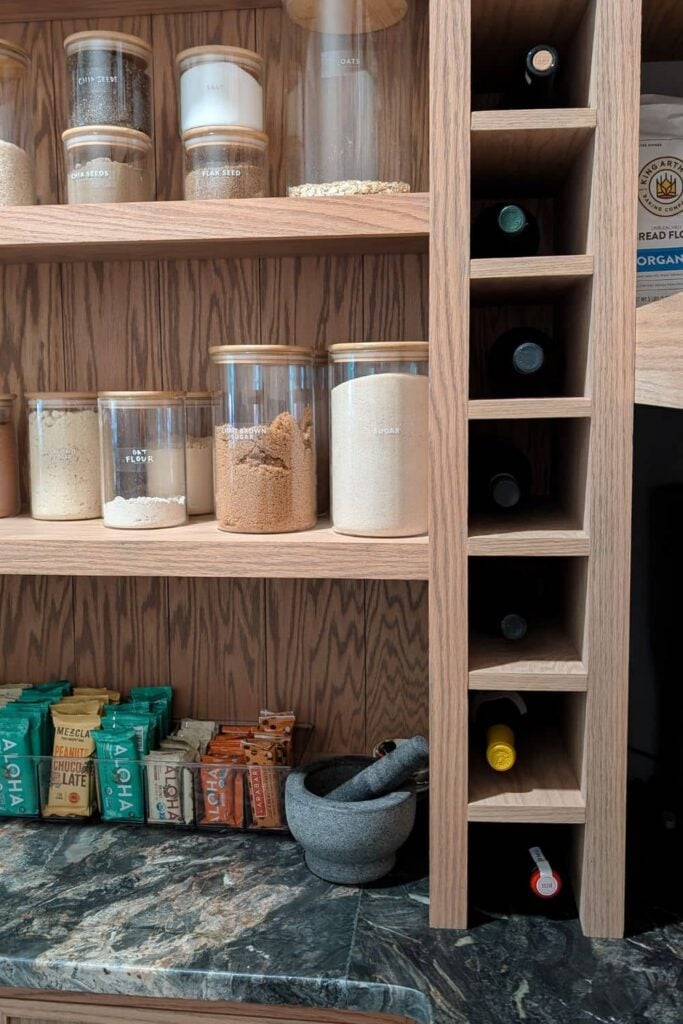DIY wine rack next to hidden appliance storage