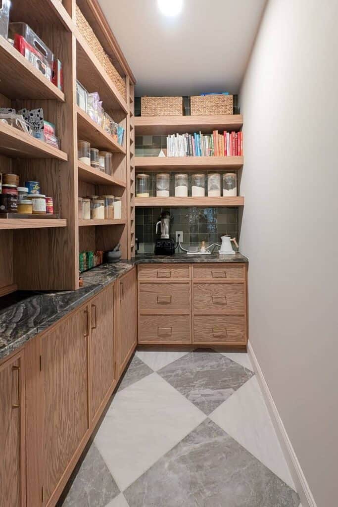 5x9 pantry with lower cabinets, black countertops, checked tile, and floating shelves