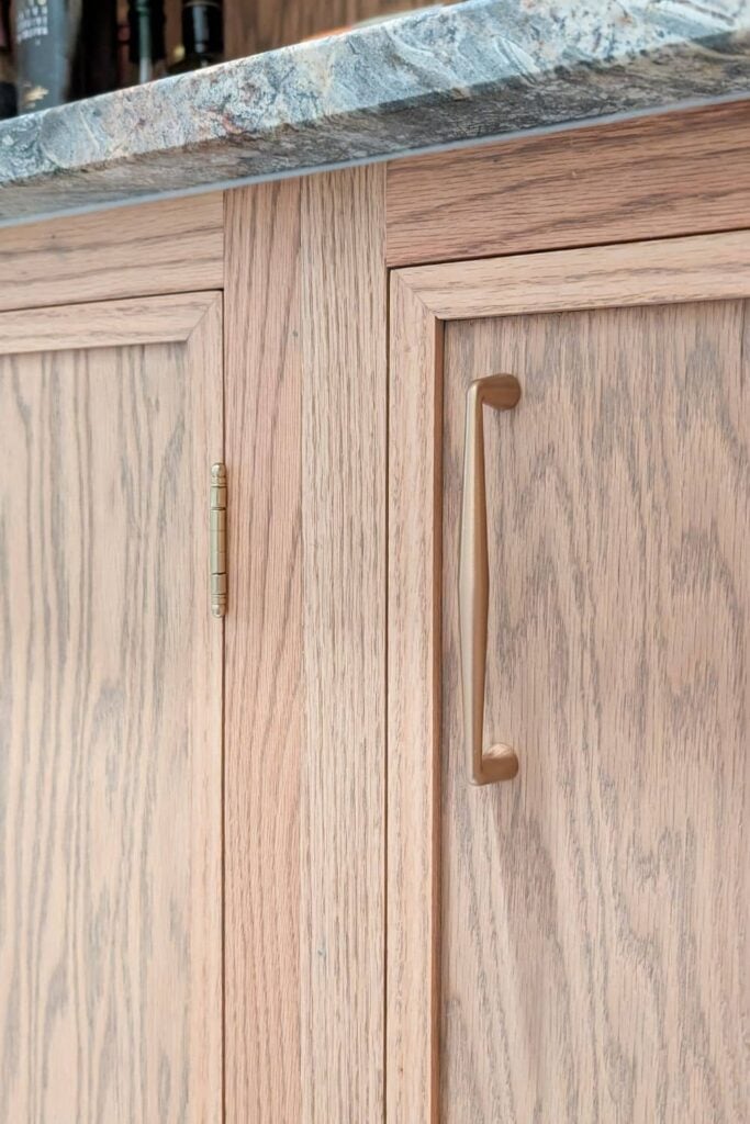 close up of inset cabinet door hinge and hardware