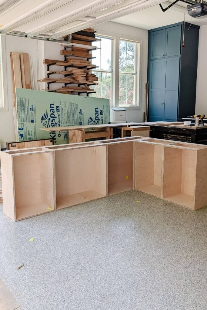 DIY lower cabinet bases laid out in garage workshop